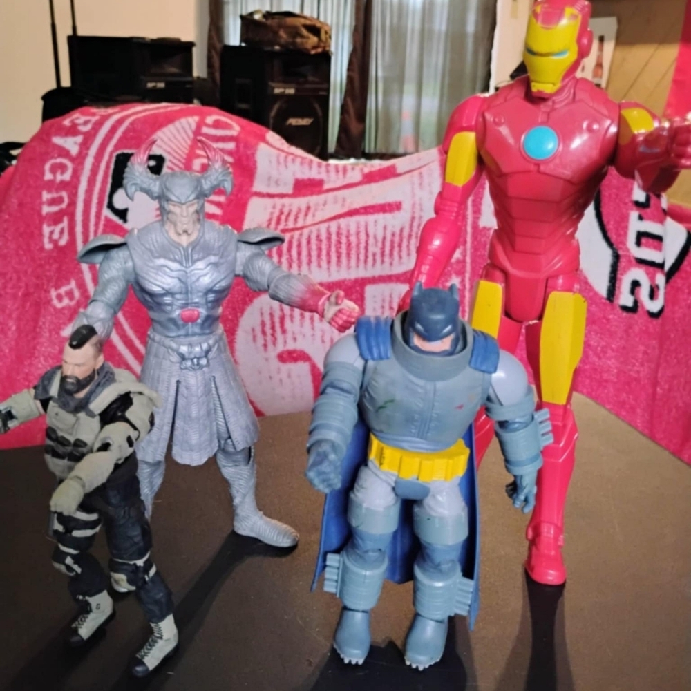 Four action figures with ironman and a chubby batman